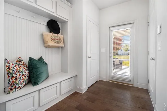 a kitchen with a refrigerator and white cabinets