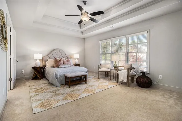 a bedroom with furniture and large windows