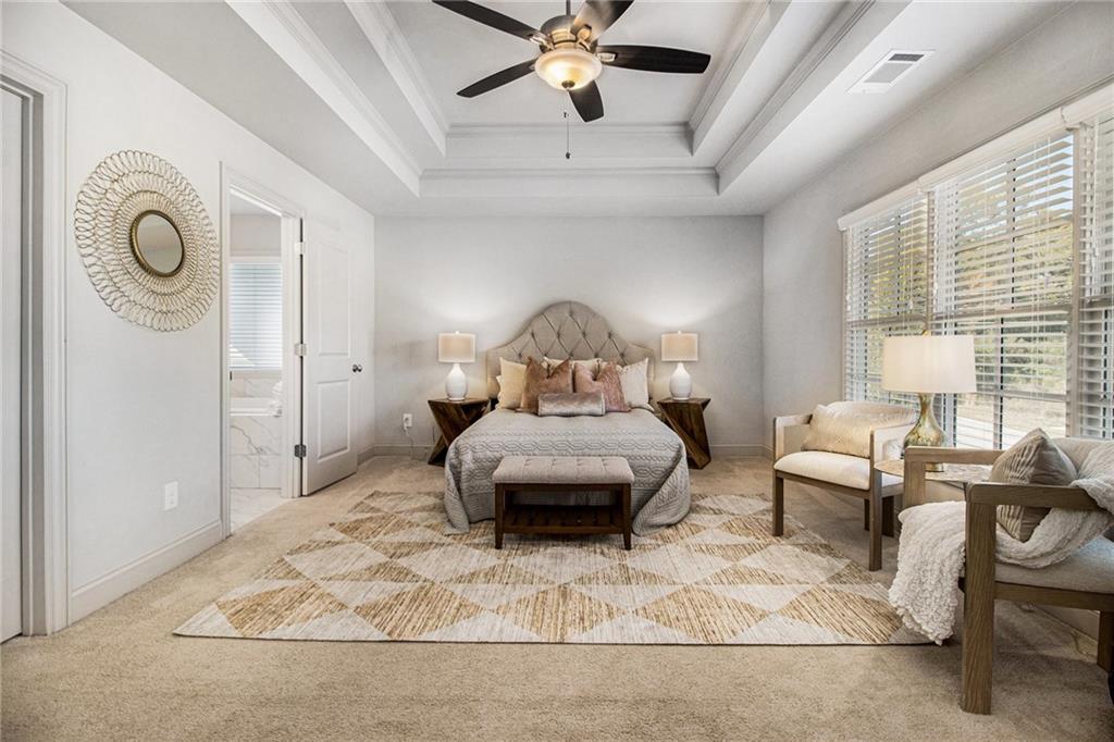 3235 Rockbridge Road Southwest Avondale Estates, GA 30002 - Photo 20 of 37 a bedroom with a bed and a chandelier