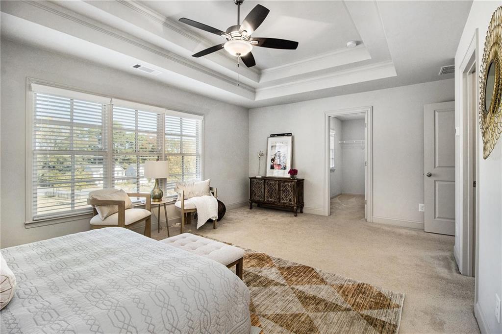 3235 Rockbridge Road Southwest Avondale Estates, GA 30002 - Photo 22 of 37 a spacious bedroom with a bed and a large window