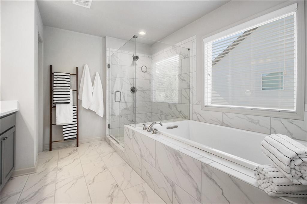 3235 Rockbridge Road Southwest Avondale Estates, GA 30002 - Photo 23 of 37 a spacious bathroom with a bathtub and a shower