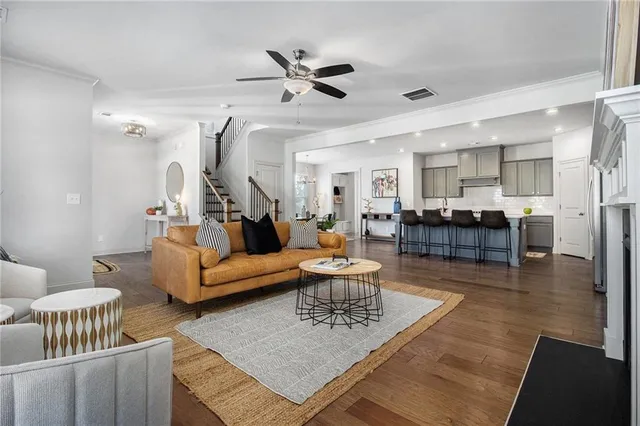 a living room with furniture and a wooden floor