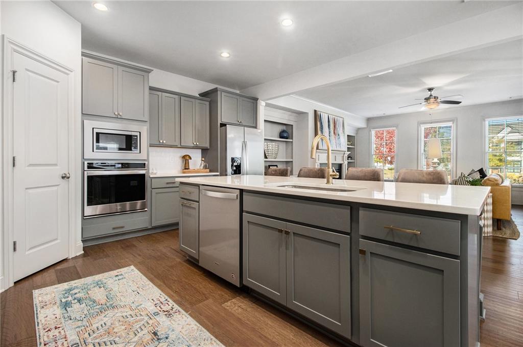 3235 Rockbridge Road Southwest Avondale Estates, GA 30002 - Photo 10 of 37 a kitchen with kitchen island granite countertop a sink cabinets and stainless steel appliances