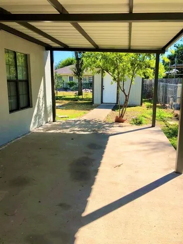 a view of a utility room with cabinets