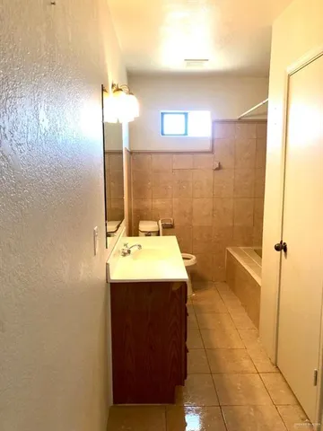 en empty room with windows and fan