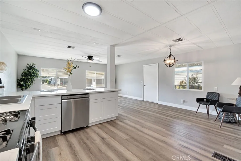 1218 East Cleveland Avenue, Unit 153 Madera, CA 93638 - Photo 11 of 39 a kitchen with granite countertop a stove a sink and a refrigerator