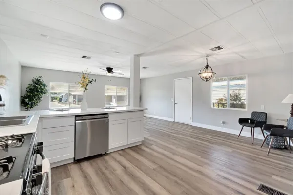 a kitchen with granite countertop a stove a sink and a refrigerator