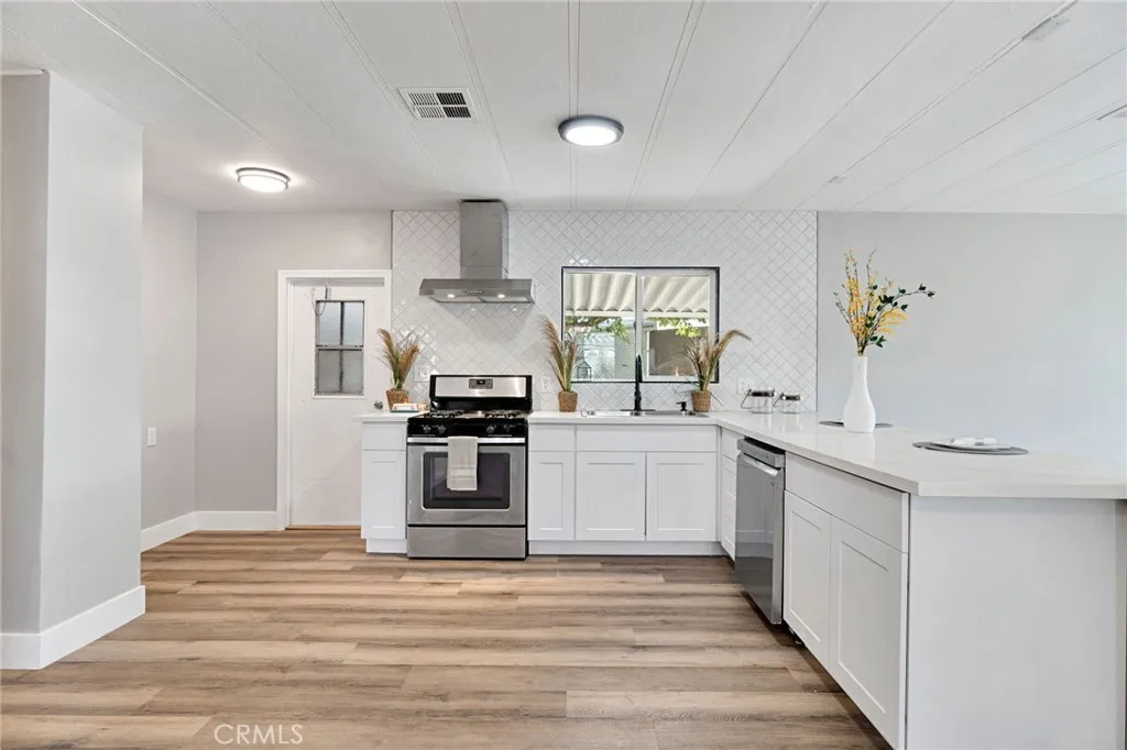 1218 East Cleveland Avenue, Unit 153 Madera, CA 93638 - Photo 13 of 39 a kitchen with stainless steel appliances a white stove top oven and cabinets