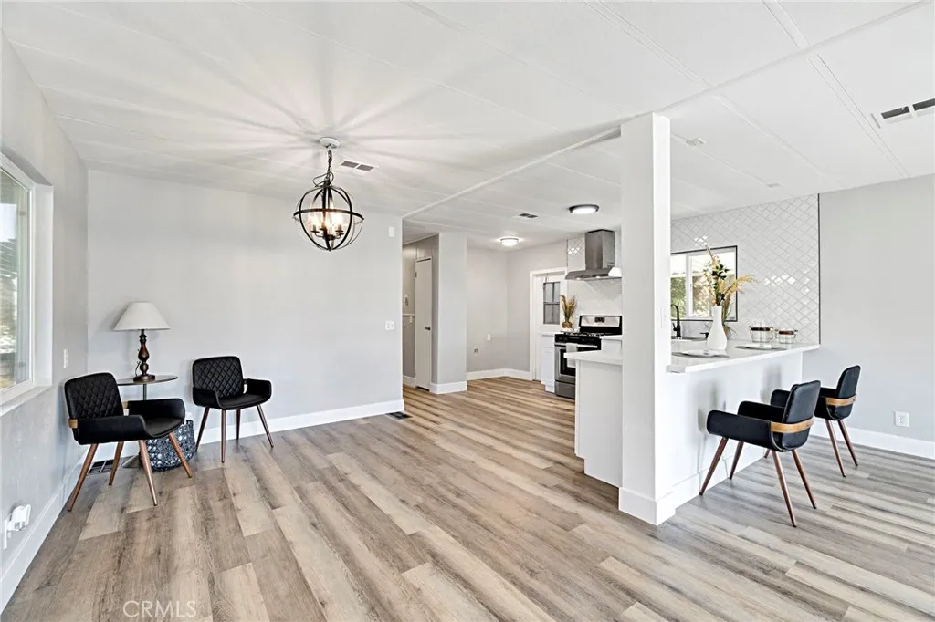1218 East Cleveland Avenue, Unit 153 Madera, CA 93638 - Photo 15 of 39 a view of a dining room with furniture and wooden floor