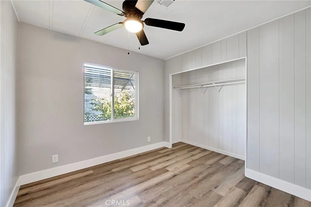 1218 East Cleveland Avenue, Unit 153 Madera, CA 93638 - Photo 18 of 39 a view of empty room with wooden floor and fan