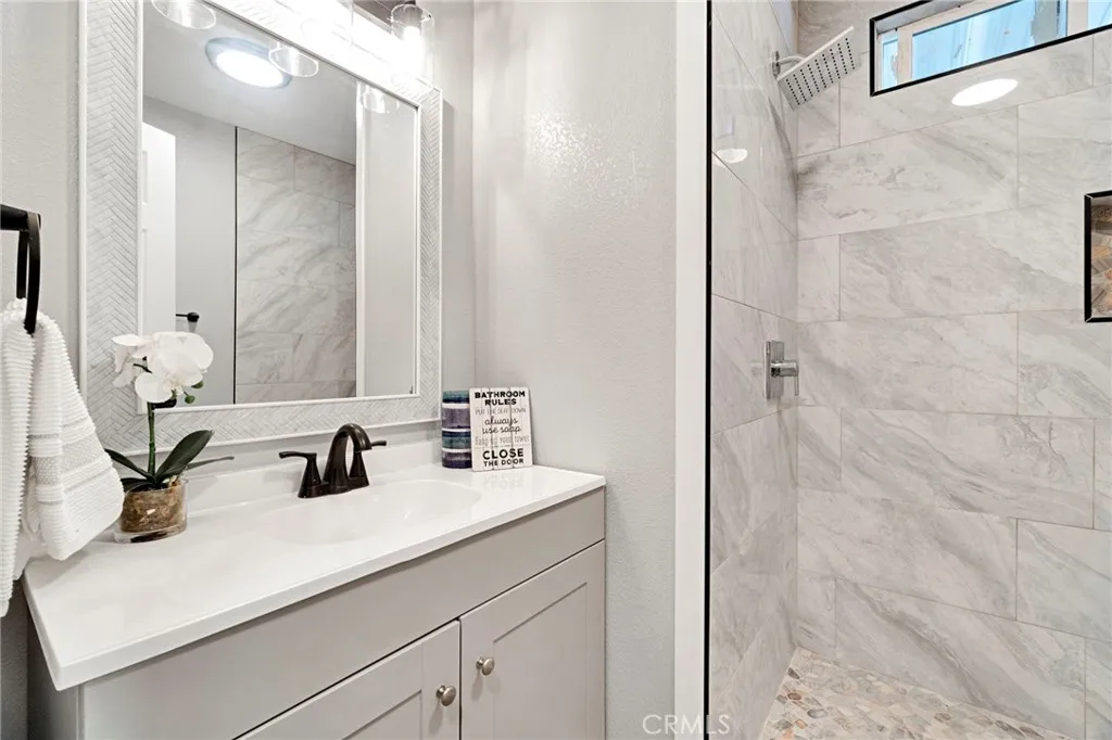 1218 East Cleveland Avenue, Unit 153 Madera, CA 93638 - Photo 19 of 39 a bathroom with a sink and a mirror
