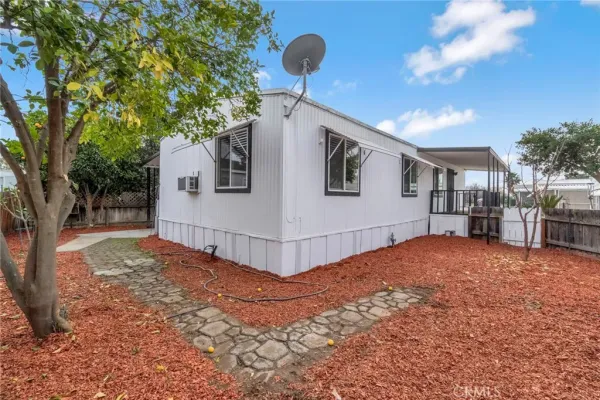 a view of a house with a backyard