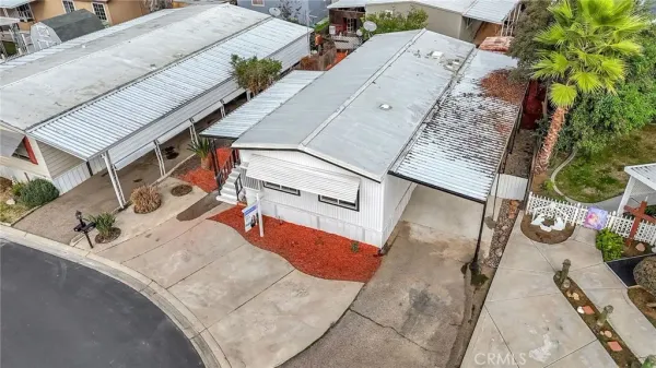 an aerial view of a house with a yard and seating area