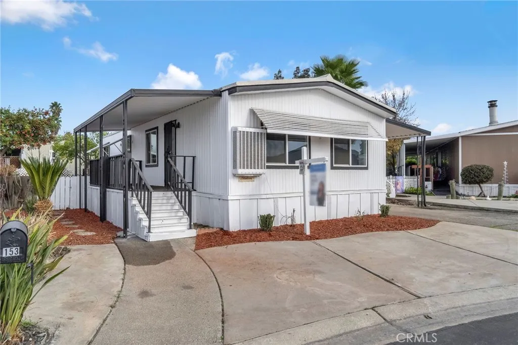 1218 East Cleveland Avenue, Unit 153 Madera, CA 93638 - Photo 3 of 39 a view of a house with a patio