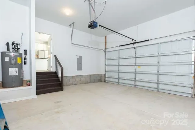 a view of an empty room with stairs and furniture