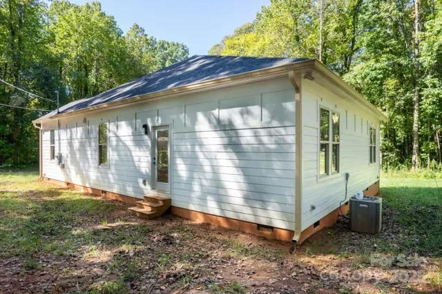 a backyard of a house with yard and outdoor seating