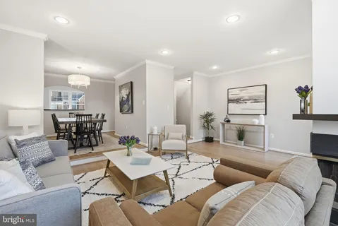 a living room with furniture kitchen view and a table