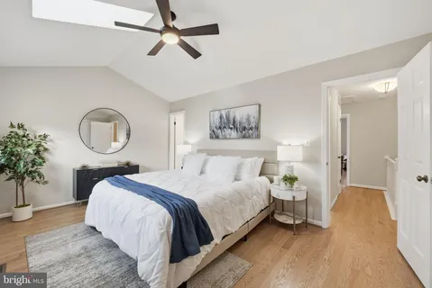 a bed sitting in a bedroom and a chandelier