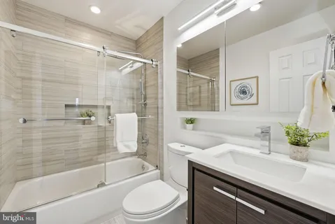 a bathroom with a sink a toilet and bathtub