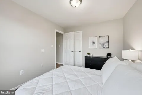 a bedroom with a bed and a lamp