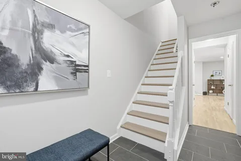a view of a hallway with staircase and floors