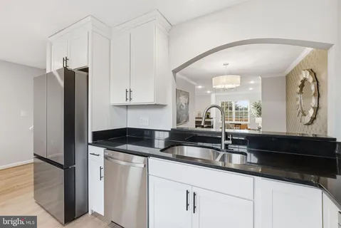 a kitchen with granite countertop a sink a refrigerator and a granite counter tops