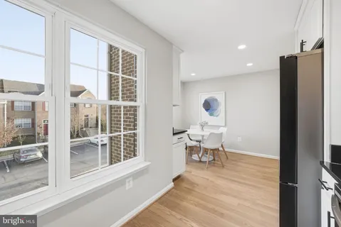 a view of a room that has a window and wooden floor