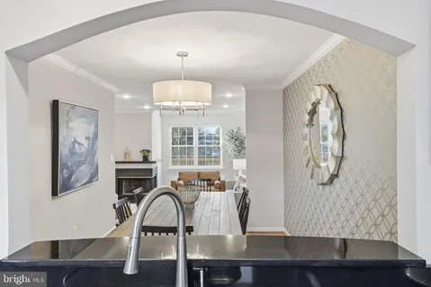 a view of a dining room with furniture and chandelier