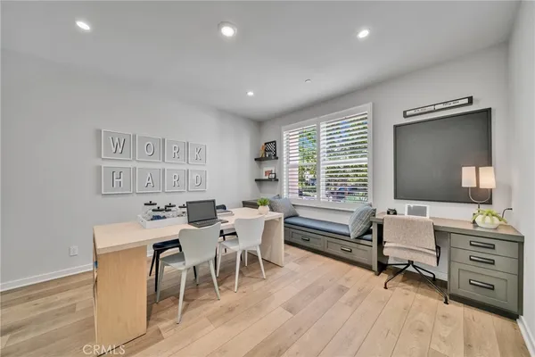 a living room with furniture a large window and a flat screen tv