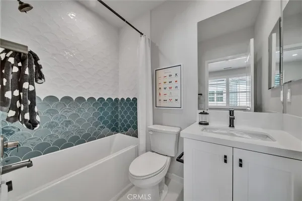 a bathroom with a double vanity sink toilet and shower
