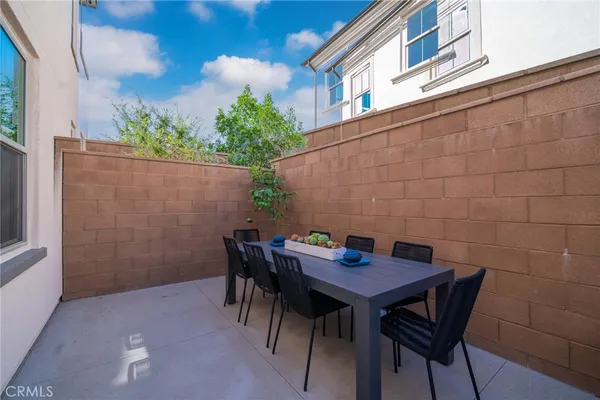 a view of a patio with table and chairs and potted plants
