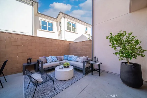 a view of a patio with couches and potted plants
