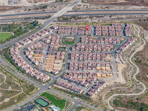 a bed with a white comforter and pillows