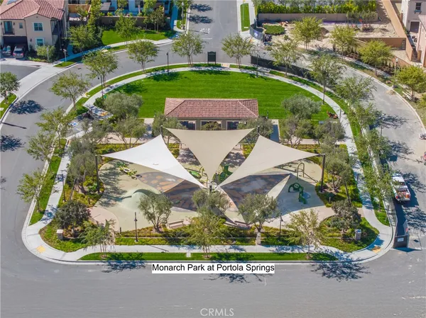 an aerial view of a residential houses with outdoor space