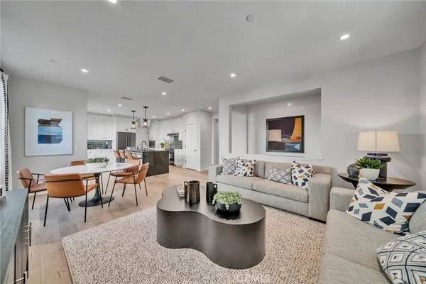 a living room with furniture wooden floor and a table