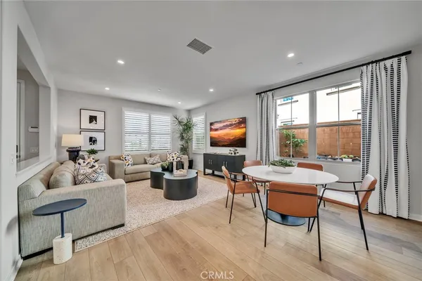 a living room with furniture a rug and a large window
