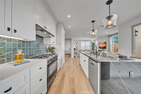 a kitchen with stainless steel appliances a stove sink and cabinets
