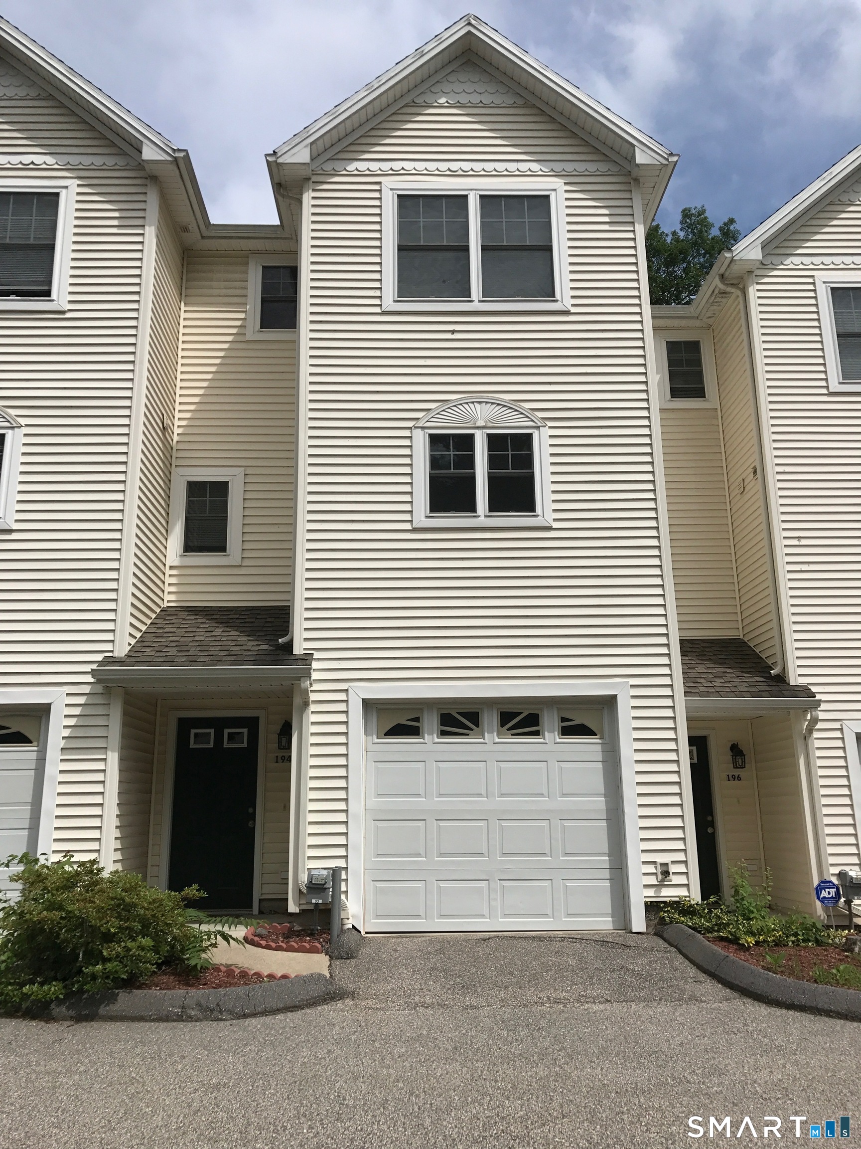 194 Summit Street Norwich, CT 06360 - Photo 1 of 24 a front view of a house with a yard and garage