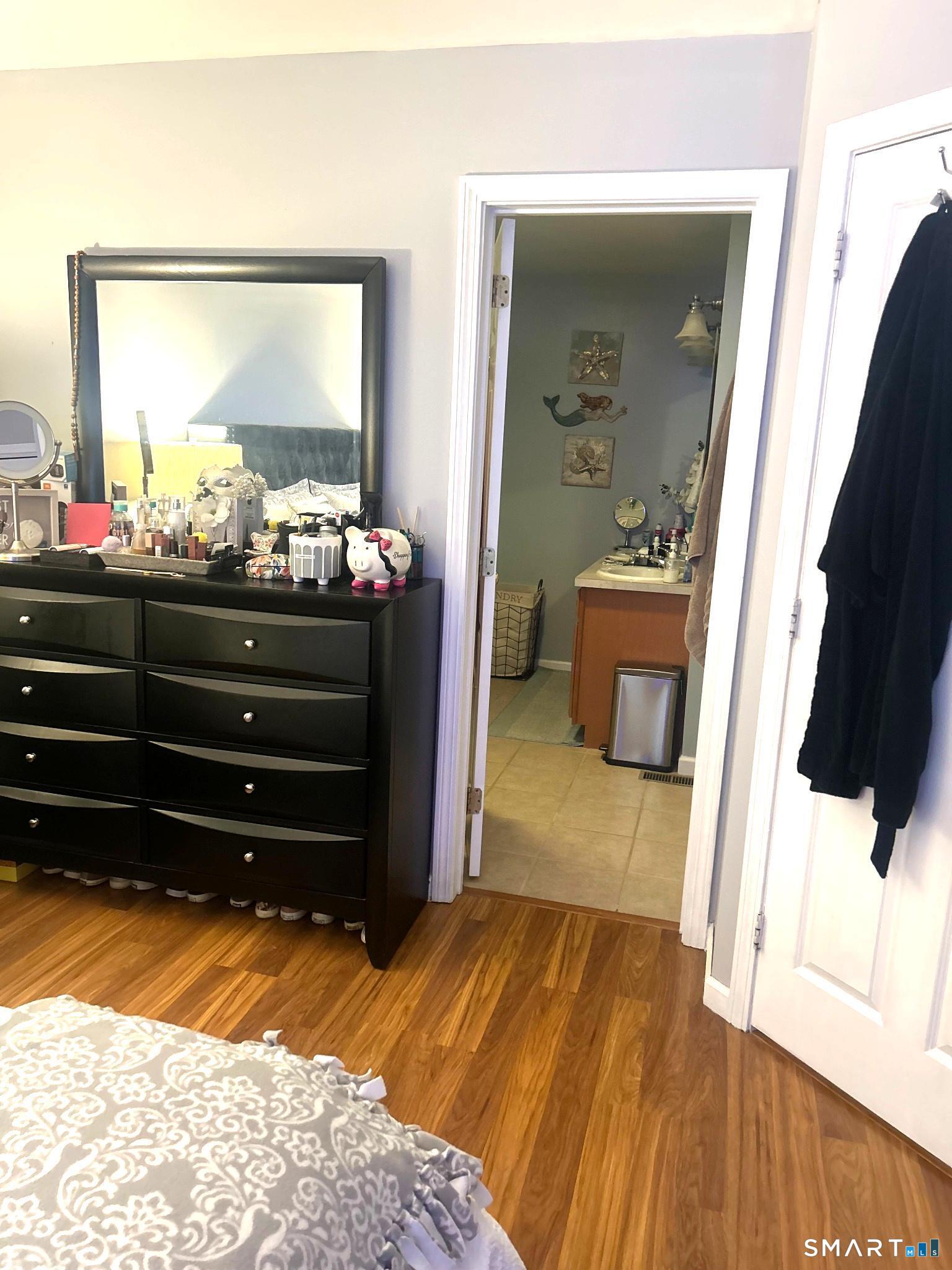 194 Summit Street Norwich, CT 06360 - Photo 14 of 24 a room with a bed and a mirror
