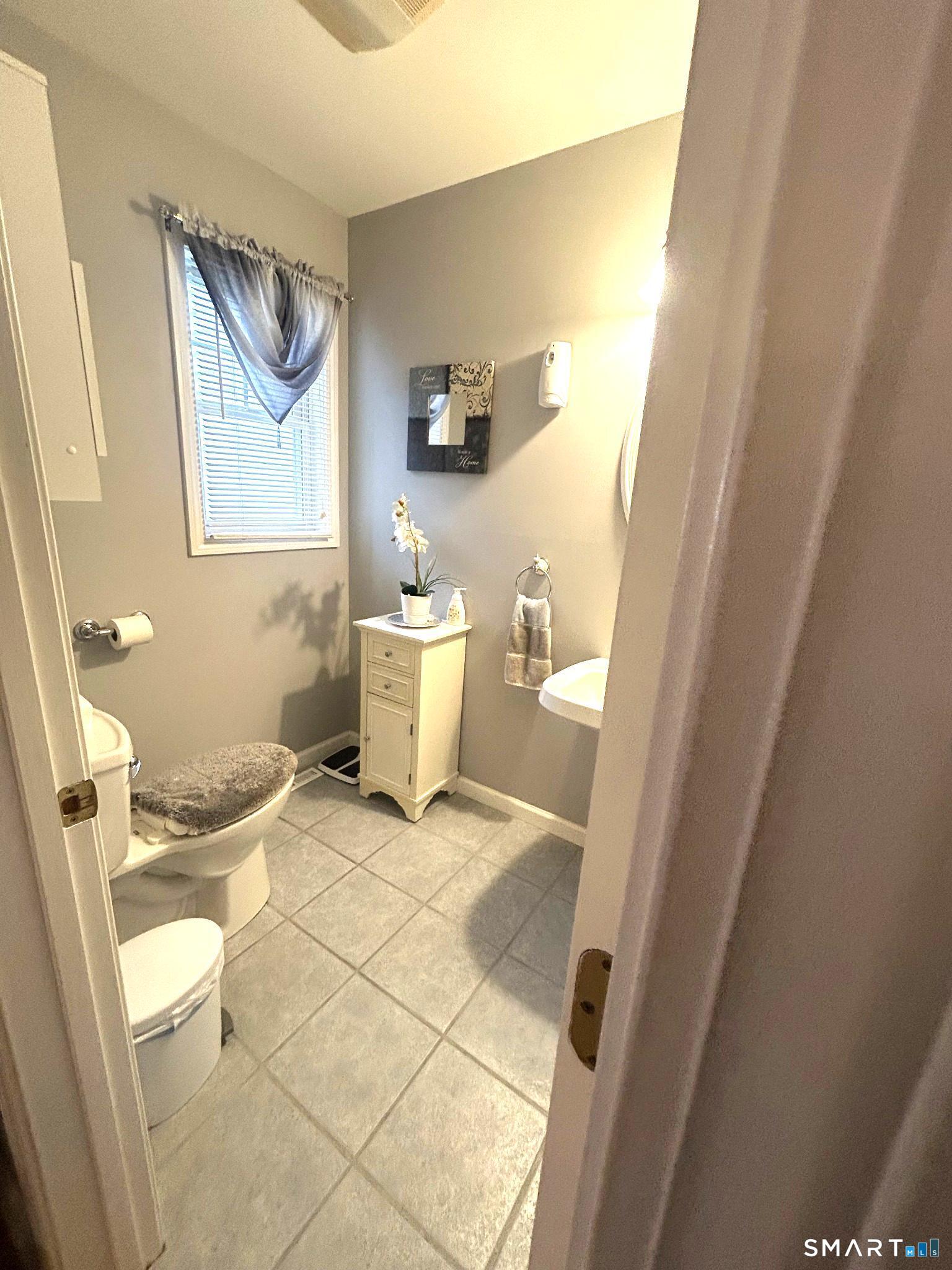 194 Summit Street Norwich, CT 06360 - Photo 5 of 24 a bathroom with a toilet and a mirror