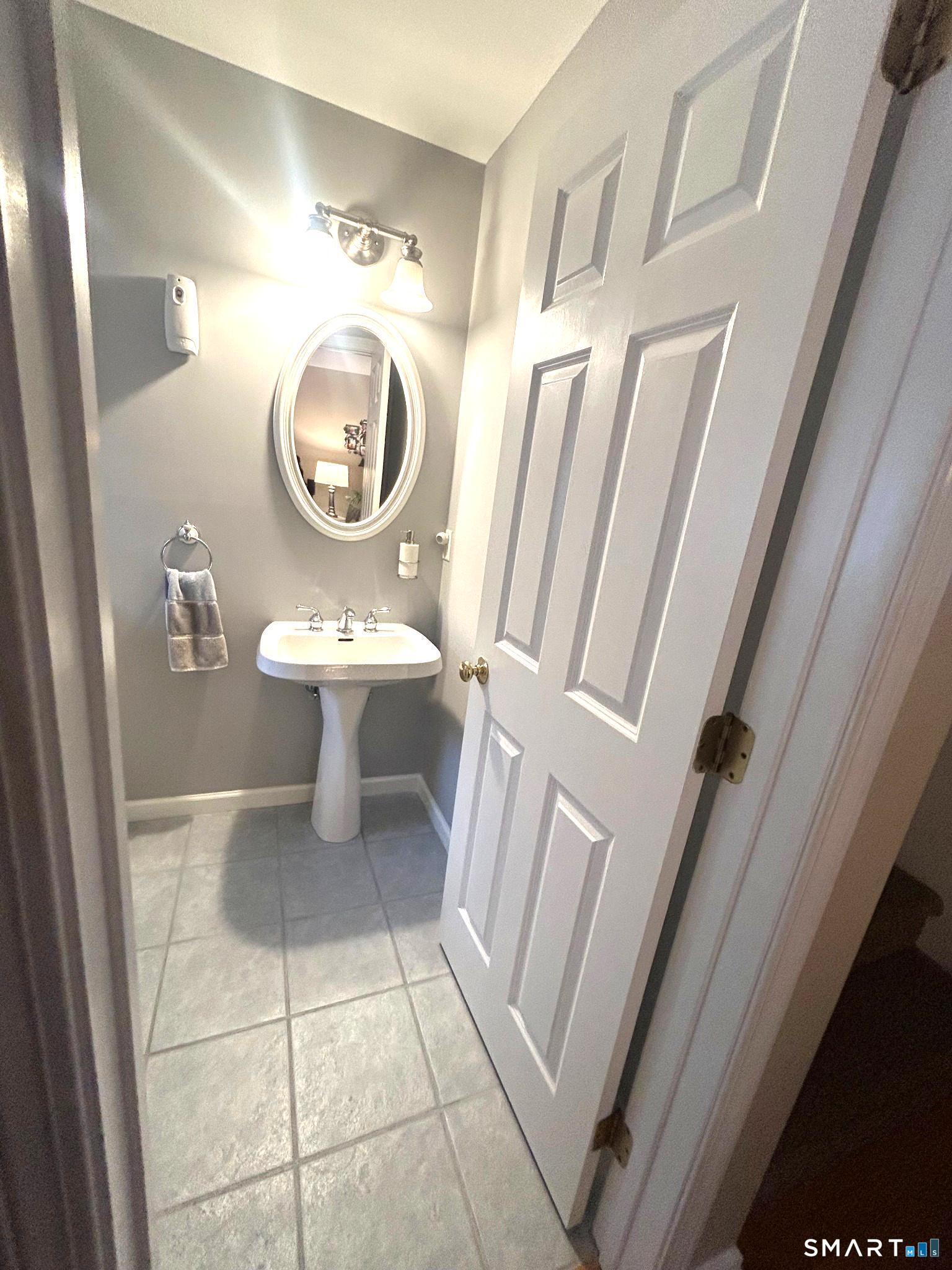 194 Summit Street Norwich, CT 06360 - Photo 7 of 24 a bathroom with a toilet a sink and a mirror