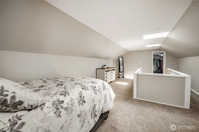 a bedroom with a bed and a couch