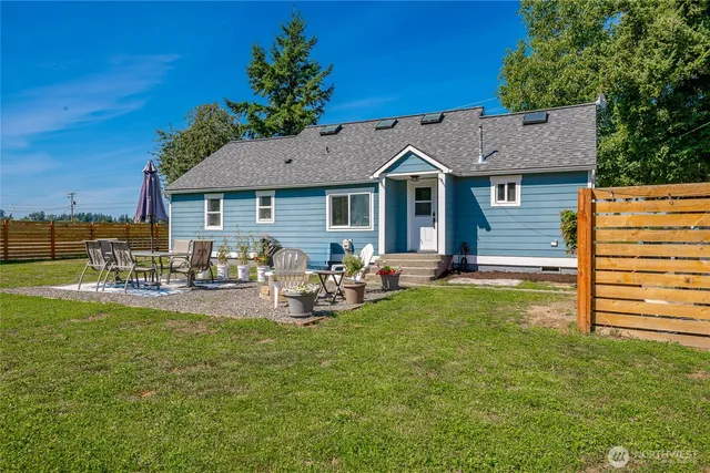 a view of a house with backyard porch and sitting area