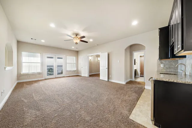 a view of a kitchen with a sink and a large window