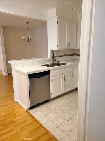 a view of a kitchen with kitchen island and stainless steel appliances