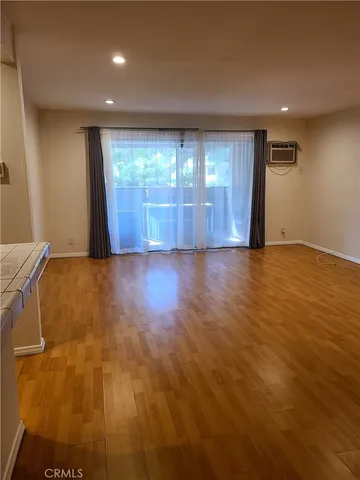 a view of a kitchen with kitchen island and stainless steel appliances