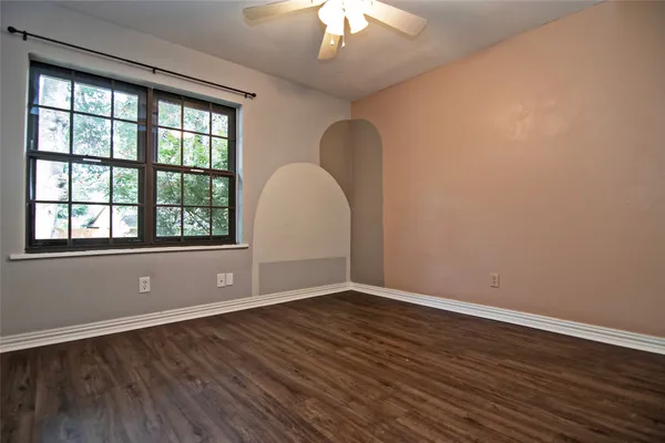 a view of room with window and wooden floor