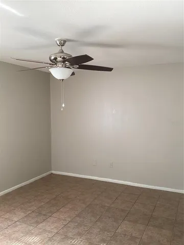 a view of a chandelier fan in an empty room