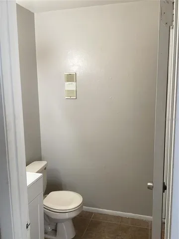 a white toilet sitting next to a shower
