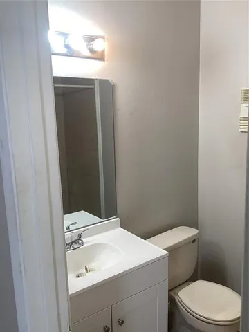 a bathroom with a sink a toilet and mirror